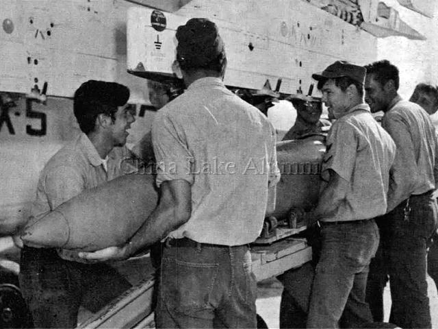 ordnance crew loads a 750-lb. bomb